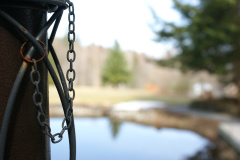 Bollard with a chain beside a lake