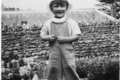 A young boy called Trent in a farm garden