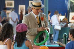 A street magician with kids