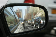 A car mirror with "Objects in mirror are closer than they appear"