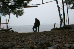 Silhouette of two people on a lake shore