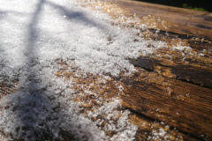 Frost on the table outside the cabin, slowly melting in the sunshine
